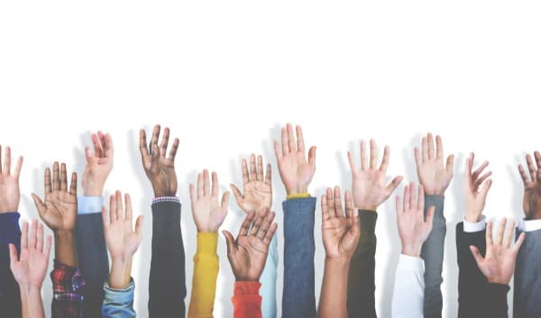 Diverse group of hands raised, diversity in clinical trials, 